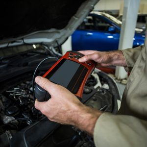hands mechanic using diagnostic tool