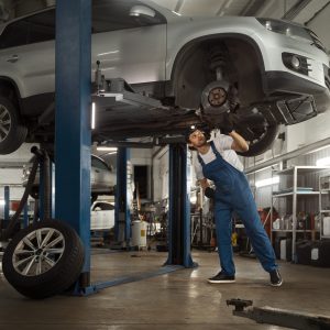 mechanic working car suspension repair shop