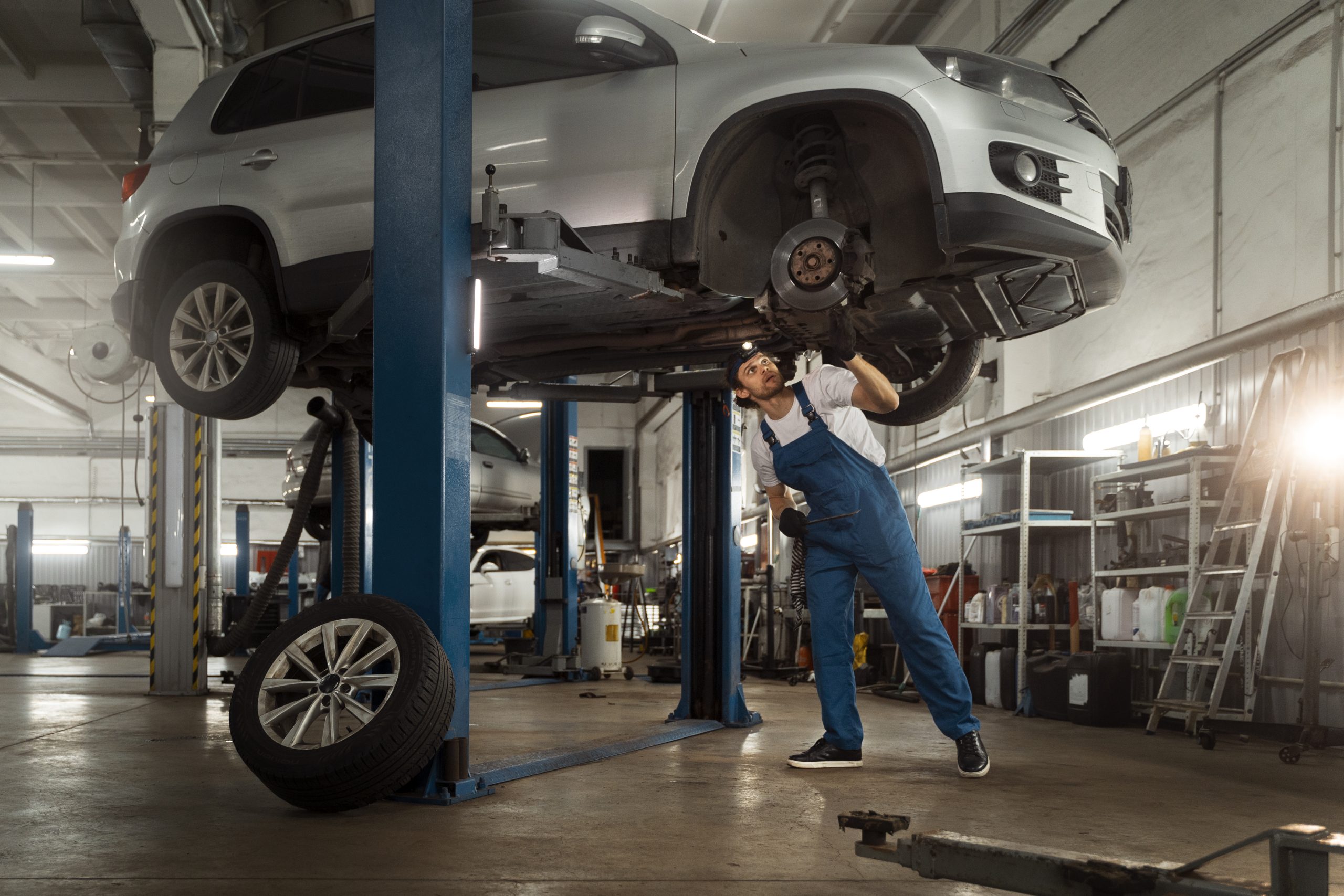 mechanic working car suspension repair shop