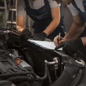 male female mechanics working shop car