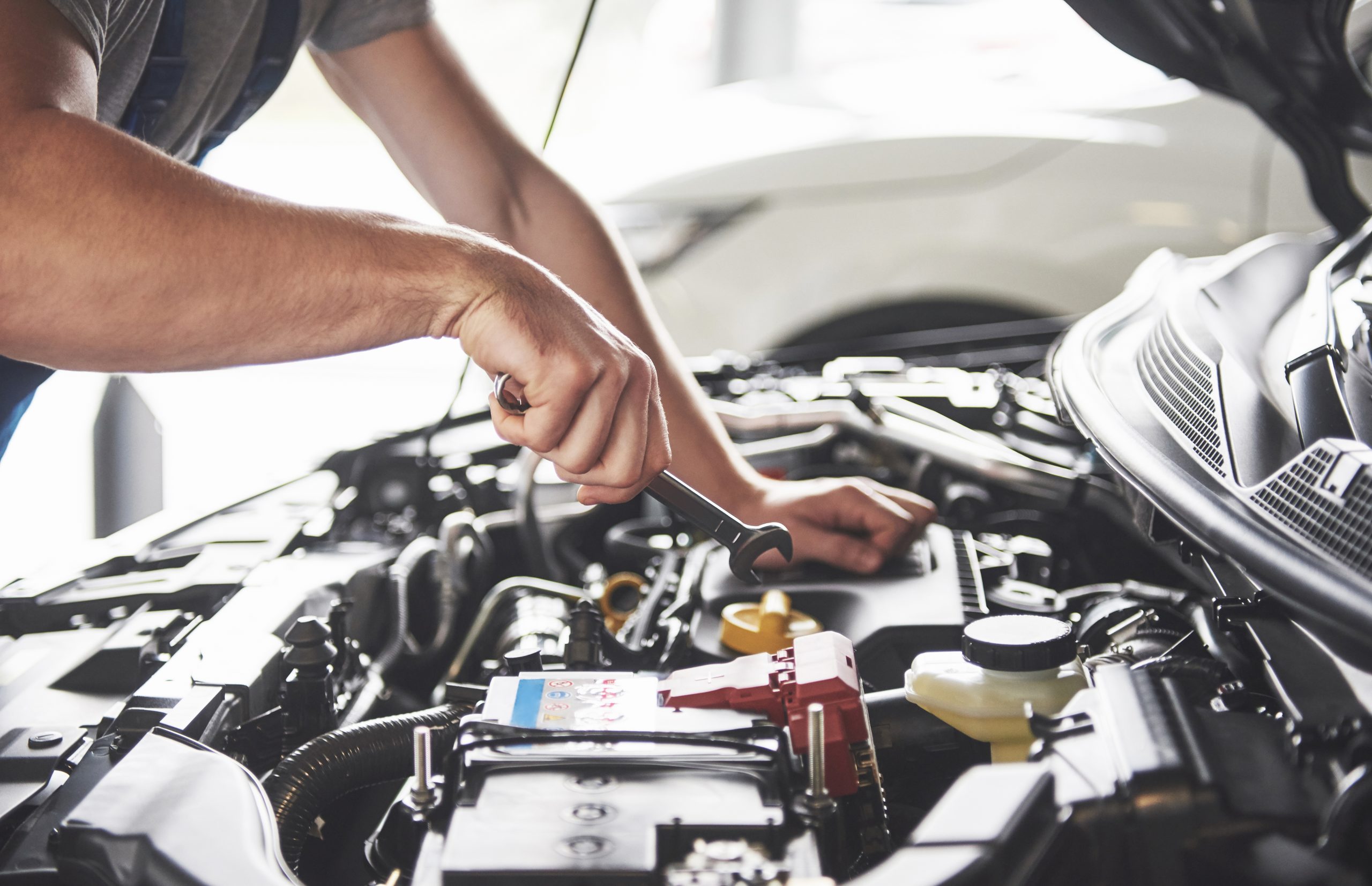 muscular car service worker repairing vehicle (1)
